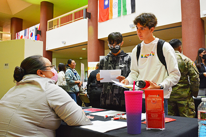 Students speak with a vendor inside Gurley Hall during the 2023 UNM-Gallup Job Fair.