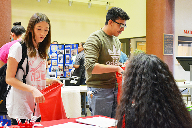 Students speak with a vendor inside Gurley Hall during the 2023 UNM-Gallup Job Fair.