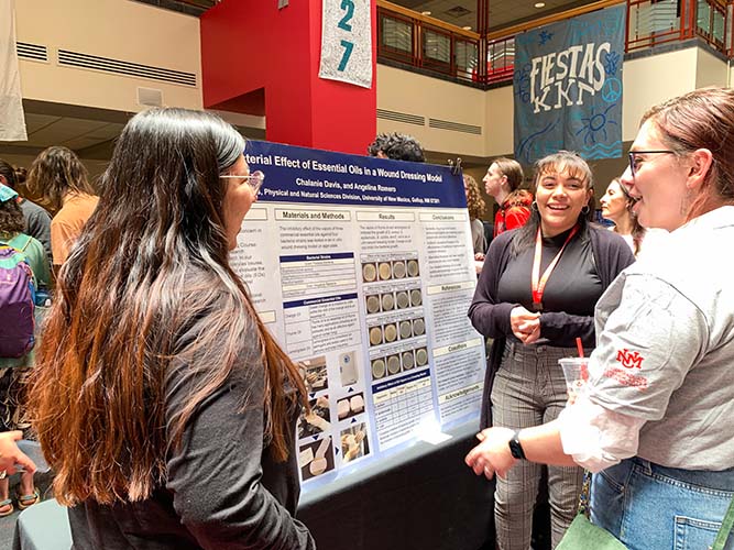 UNM-Gallup students Chalanie Davis, left, and Angelina Romero present their poster during the Undergraduate Research Opportunity Conference at The University of New Mexico main campus in Albuquerque on April 12, 2024. 