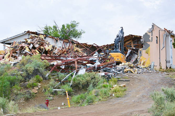 Workers for C&C Demolition Services use an excavator to tear down Lions Hall at The University of New Mexico-Gallup on Friday, June 14, 2024. 