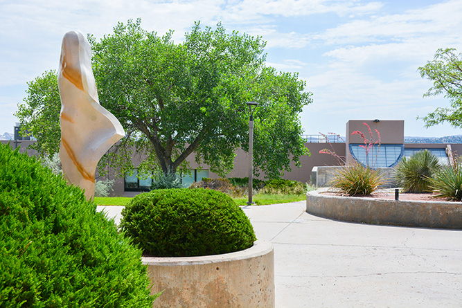 The back of “White Deer of Autumn,” a sculpture by Denny Haskew, stands out in the outdoor courtyard between Gurley Hall and Calvin Hall Center on The University of New Mexico-Gallup campus on July 18, 2024.