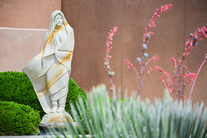 “White Deer of Autumn,” a sculpture by Denny Haskew, stands in a raised landscape bed in the outdoor courtyard at The University of New Mexico-Gallup campus on July 18, 2024.