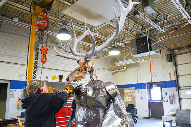 Raquel Martinez puts the finishing touches on her sculpture of an elk centaur inside the welding shop at The University of New Mexico-Gallup on Wednesday, Aug. 7, 2024.