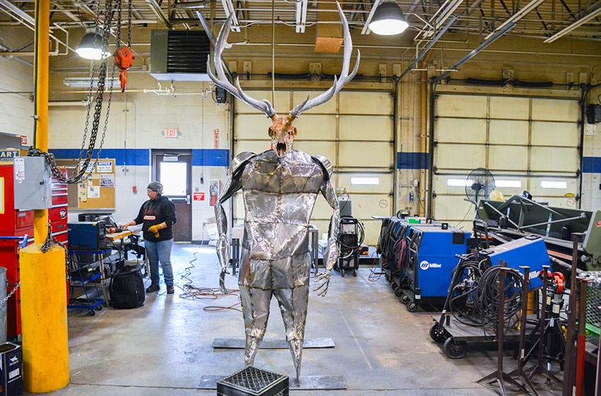 “Raquel Martinez puts away her equipment as her sculpture of an elk centaur stands tall inside the welding shop at The University of New Mexico-Gallup on Wednesday, Aug. 7, 2024.  