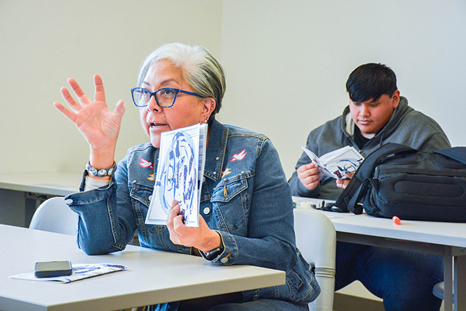 Sandra Freeland, education coordinator for the George Galanis Multicultural Center, gives feedback after a student presentation during the Professional and Technical Communication class at The University of New Mexico-Gallup on May 6, 2025.