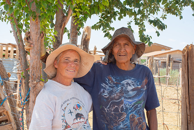 Homeowners Kathi Trujillo and Candelario “Kenny” Calavaza stand together for a photo at their home in Zuni.