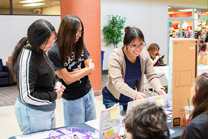 Students interact with the McKinley Academy Project EDSA booth during The University of New Mexico-Gallup's Campus Safety Fair in the Gurley Hall Commons on Thursday, Sept. 18, 2025.