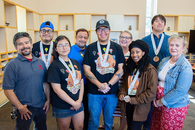 UNM-Gallup SkillsUSA Chapter members and advisors pose for a group photo inside Zollinger Library at The University of New Mexico-Gallup on June 16, 2026. From left: Frank Sanchez, Donovan Padilla, Layla Perry, Markos Chavez, Sonny Gene, Jayme McMahon, Ariana 