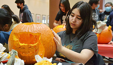 UNM-Gallup students, staff and faculty celebrate Halloween with pumpkin carving, history lecture and costume contest